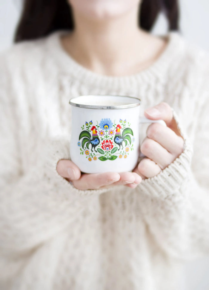 a close up photo of a woman holding a mug