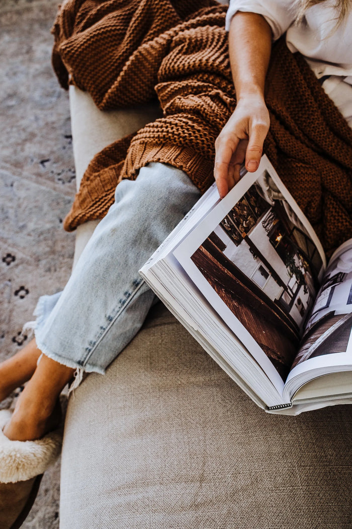 overhead photo of a person looking at a photo book