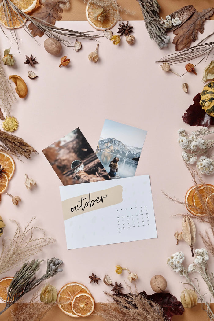 overhead photo of a calendar surrounded by dried fruit and plants