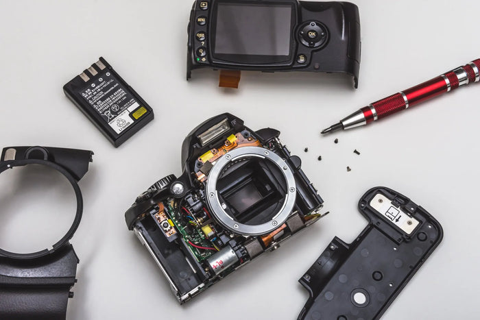 overhead photo of broken DSLR camera and parts